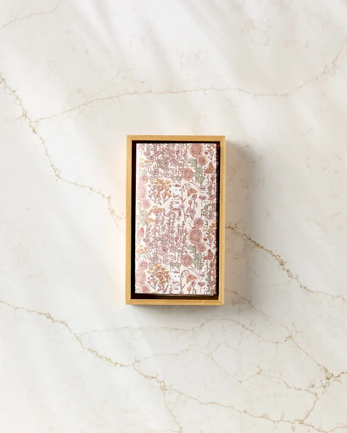 A rectangular box of Elisabeth Wing Fall Forest reusable paper towels with a floral pattern rests on a light-colored marble surface with subtle veining.