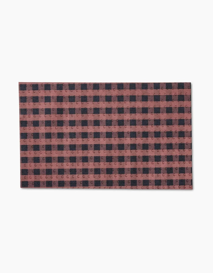 The GEOMETRY Fall Gingham is a rectangular, reusable mat with a red and black buffalo plaid pattern—an eco-friendly alternative to Not Paper Towels, shown against a white background.