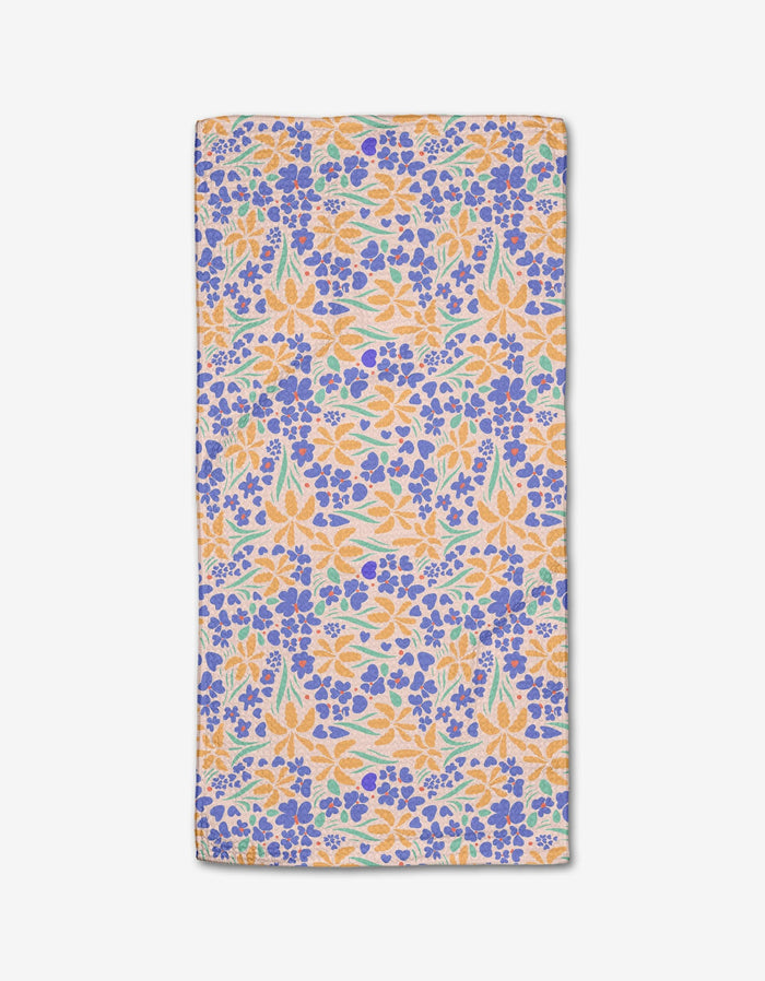 The February bar towel by Elisabeth Wing features a vibrant floral pattern with orange, yellow, blue, and green flowers on white Geoweave fabric for superior absorbency.