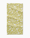 The Ashley Celena Field of Wildflowers Bar Towel is a yellow rectangular towel with a white floral and leaf pattern in various sizes on textured Geoweave fabric for a natural, slightly wrinkled look.