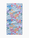 The Floral Garden Bar Towel by Charlie Rowan Designs features a colorful floral and geometric pattern on Geoweave fabric, with blue, purple, white, and red flowers, green leaves, and multicolored stripes on a light background.