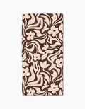 Floral Reverie by Gerdadzy is a beige rectangular cloth napkin with an abstract dark brown floral pattern of stylized flowers and wavy leaves, crafted from recycled materials for an eco-friendly touch.
