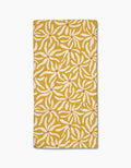 The Gerdadzy Floral Spell is a folded yellow napkin made from recycled towel material, decorated with a white floral pattern and red dots in each flowers center, set against a white background.
