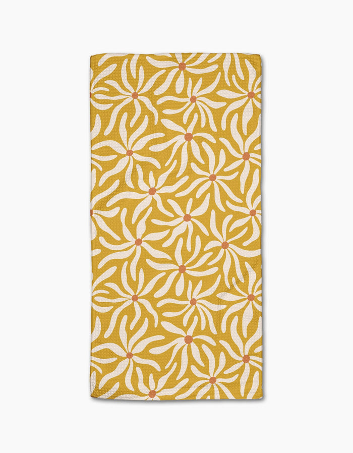 The Gerdadzy Floral Spell is a folded yellow napkin made from recycled towel material, decorated with a white floral pattern and red dots in each flowers center, set against a white background.