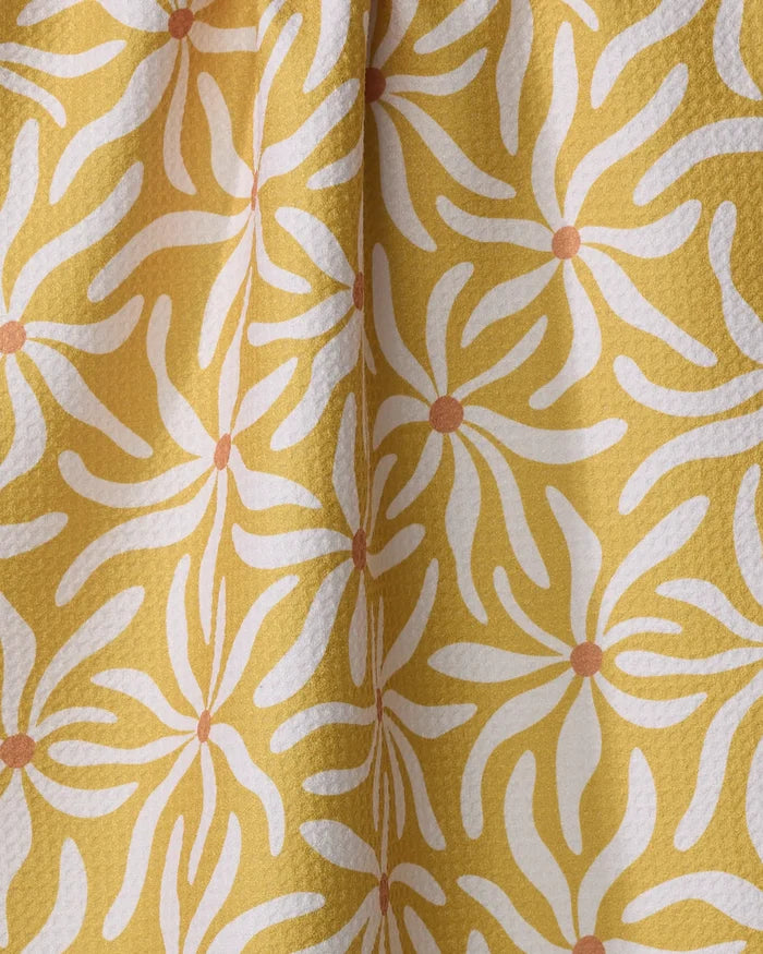 The Gerdadzy Floral Spell is a yellow absorbent dish towel with a textured surface, featuring white abstract flowers each accented with an orange dot.