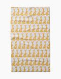 The Hufton Studio Floral Spring Bunny tea towel is ultra-absorbent and white, featuring neat horizontal rows of yellow bunny silhouettes with floral designs across the entire surface.