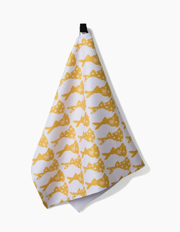 A white recycled kitchen towel by Hufton Studio, named Floral Spring Bunny, featuring a repeating yellow floral bunny pattern and hanging by a black loop against a plain white background.