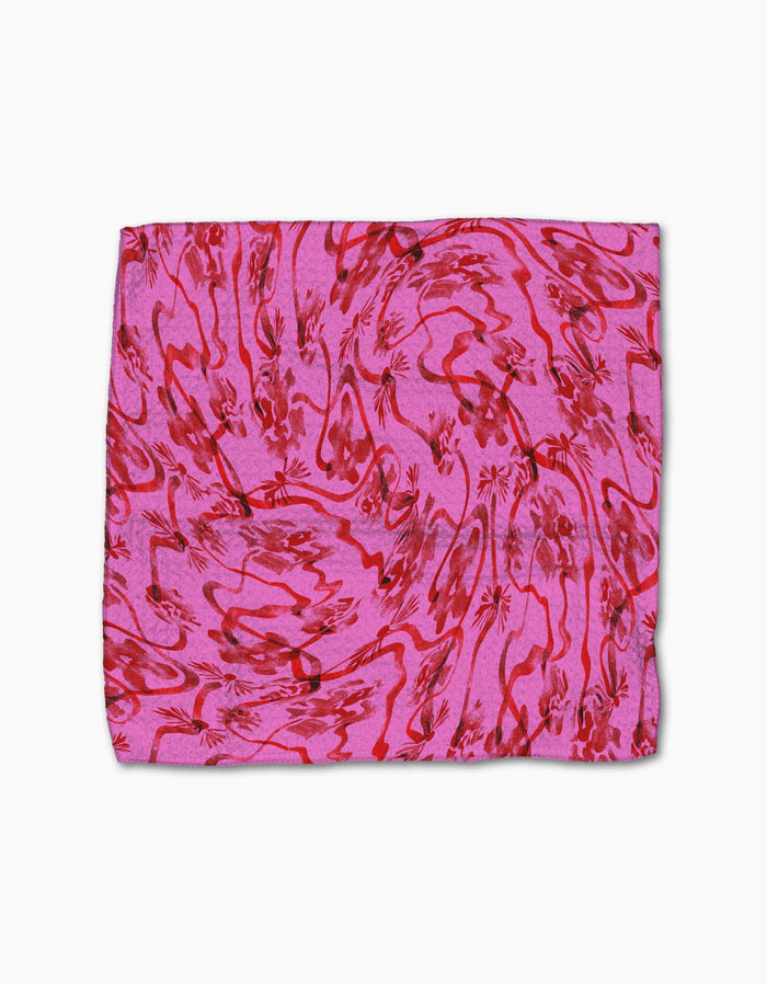 The Geometry Floral Swirls Pink Geoweave cloth features a pink rectangle with red abstract floral and wavy patterns, displayed flat on white—ideal as a decorative dishcloth or stylish kitchen towel.
