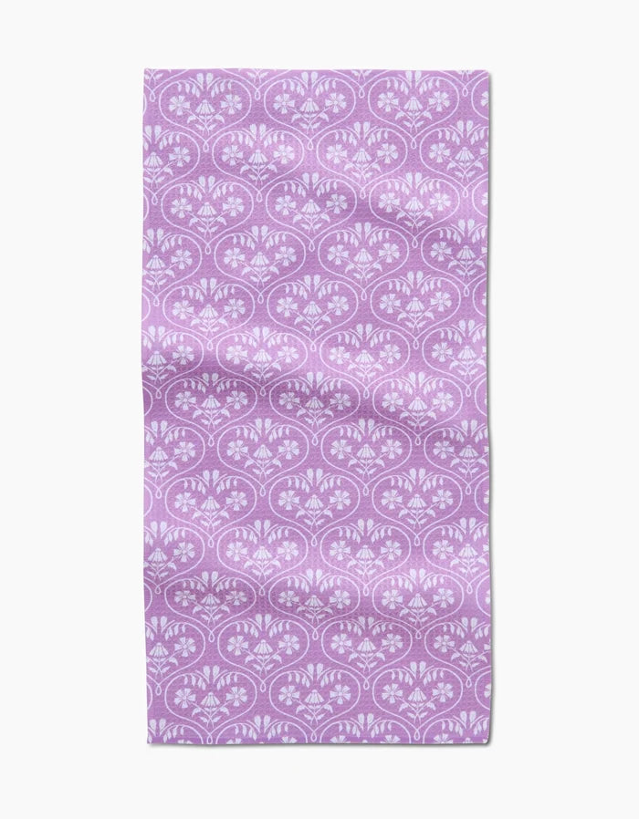 The Hufton Studio Floral Vine Hearts rectangular bar towel features Geoweave fabric with a light purple background and a repeating white floral and fan-shaped pattern. The fabric has a slightly wrinkled look.