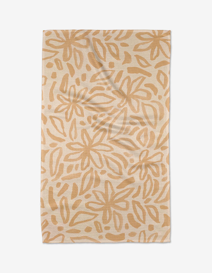 The Jen B. Peters Floral towel is beige, ultra-absorbent, and features an abstract pattern of overlapping leaf and flower shapes in light tan, shown flat on a white background.