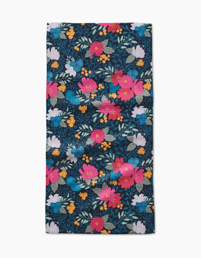The Flower Bouquets Bar Towel by Katie OShea features vibrant pink, red, yellow, white, and orange flowers with green leaves on a dark background, crafted from durable Geoweave fabric.