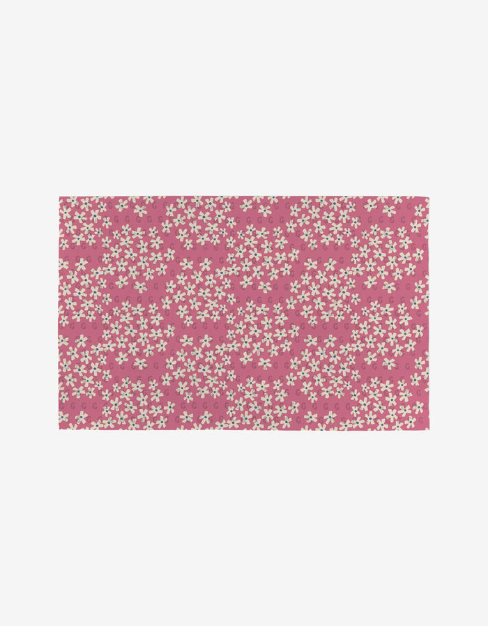 Flower Parade by Lizzie Clark: a pink rectangular mat with a repeating white floral pattern, made from post-consumer recycled materials as an eco-friendly choice. Not Paper Towels.