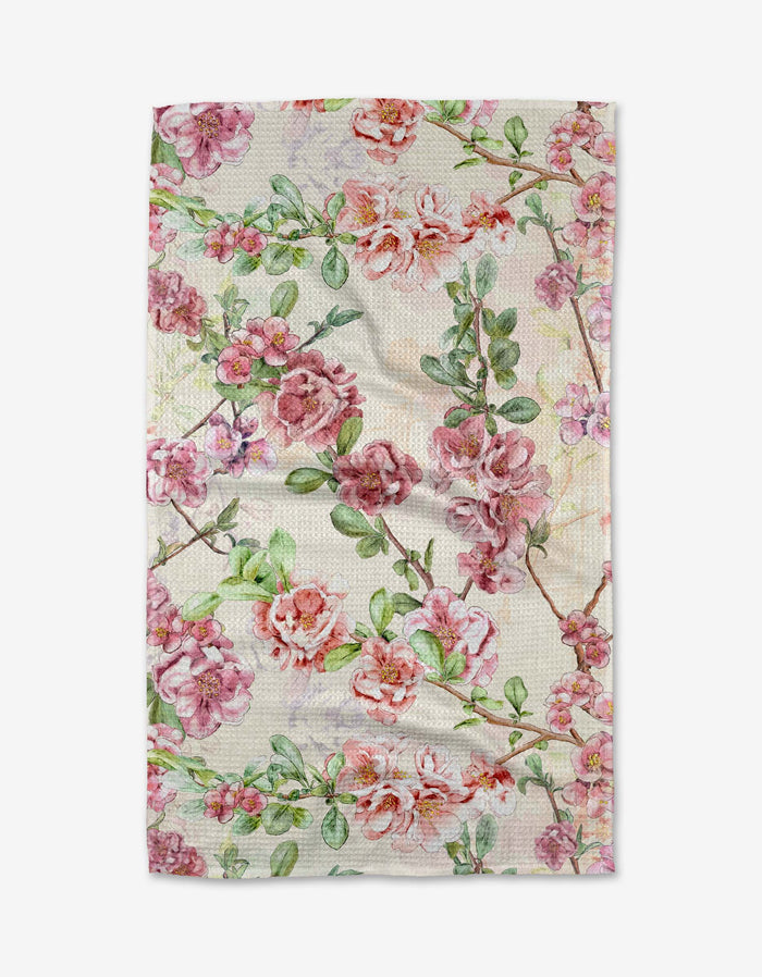 The Flowering Quince by Pascale Dilger is a rectangular cloth with pink and red rose floral patterns and green leaves on a light background, made from ultra-absorbent Geoweave fabric and shown flat on a white surface.