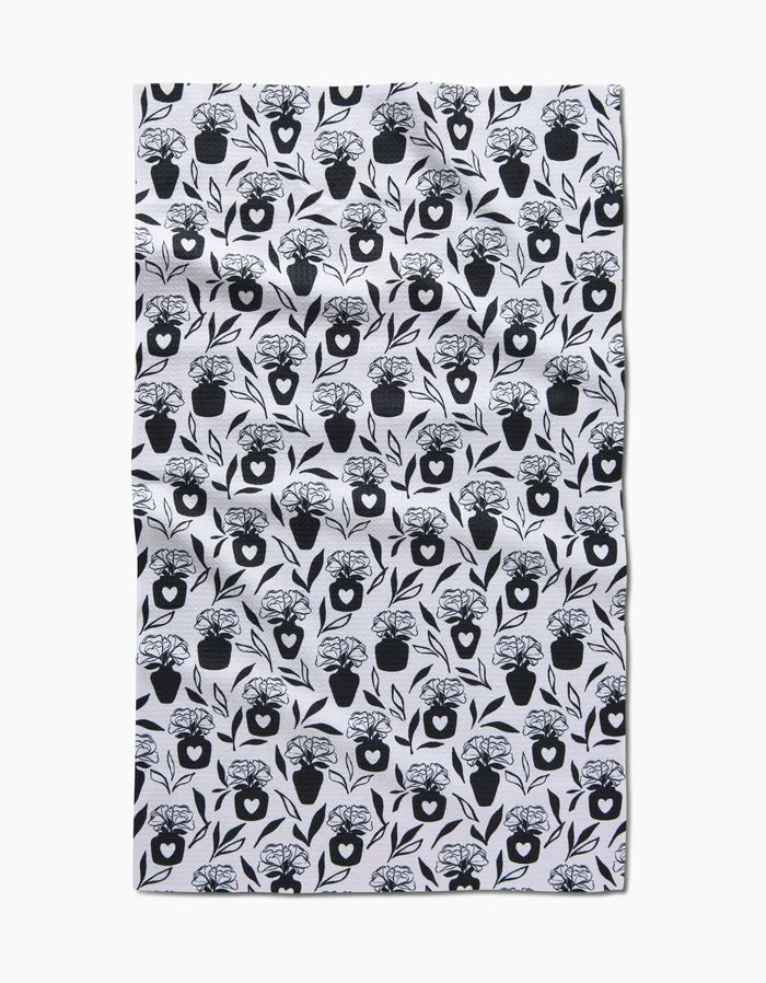 The Flowers for Me tea towel by Charlie Rowan Designs features a repeated black floral vase pattern on white, made from quick-drying fabric with a slightly wrinkled look, photographed on a plain white background.