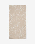 Aubrey Fairchilds Flowing Floral tea towel is beige, rectangular, and crafted from Geoweave fabric with a subtle texture and a white leaf and branch design.