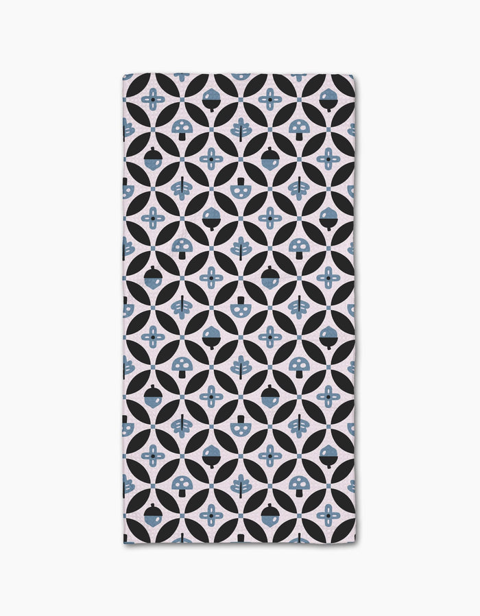 The Forest Findings rectangular bar towel by Anette Heiberg showcases black and light blue geometric shapes on white Geoweave fabric, blending circles, diamonds, and abstract floral motifs in a stylish pattern.