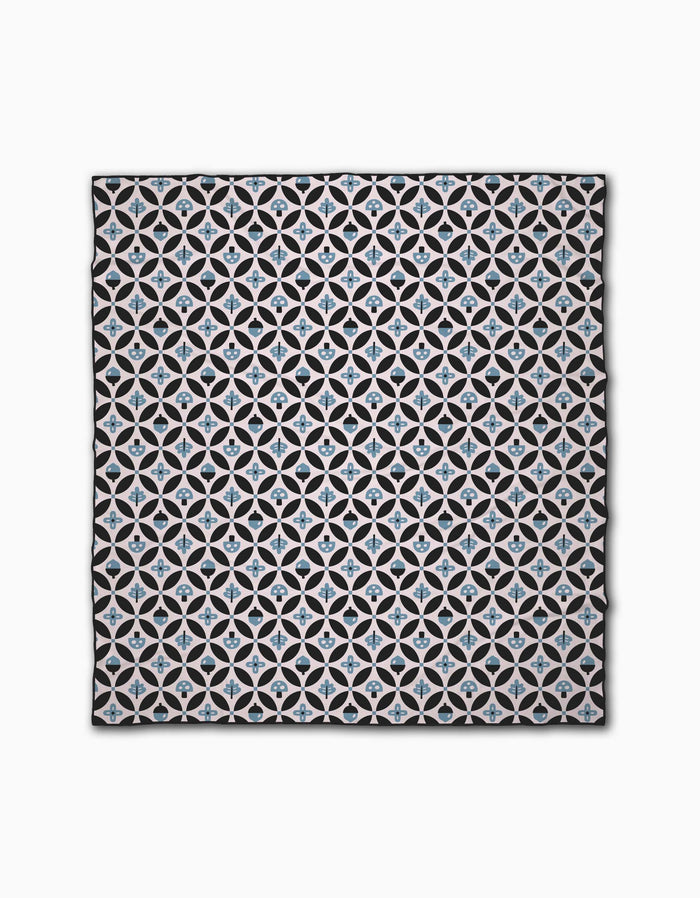 The Forest Findings Beach Blanket by Anette Heiberg is rectangular and features a repeating geometric pattern of white intersecting circles with blue and beige star shapes at the center, all set against a black background.