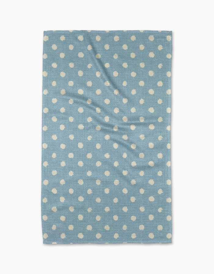 The Geometry Freckle Light Blue towel, featuring evenly spaced white polka dots on a rectangular light blue quick-drying fabric, is laid flat on a white background—ideal as a stylish and functional kitchen tea towel.