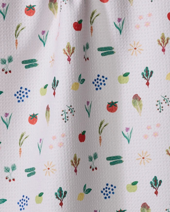 The "Fresh Produce" tea towel by Brittany Jepsen features a white textured design with colorful, hand-drawn fruits and veggies like apples, tomatoes, carrots, and cucumbers—perfect for adding charm to any kitchen.