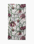 The Pascale Dilger Fritillaria tea towel features ultra-absorbent Geoweave fabric and a botanical print of purple and pink fritillaria flowers with green stems on a white background.