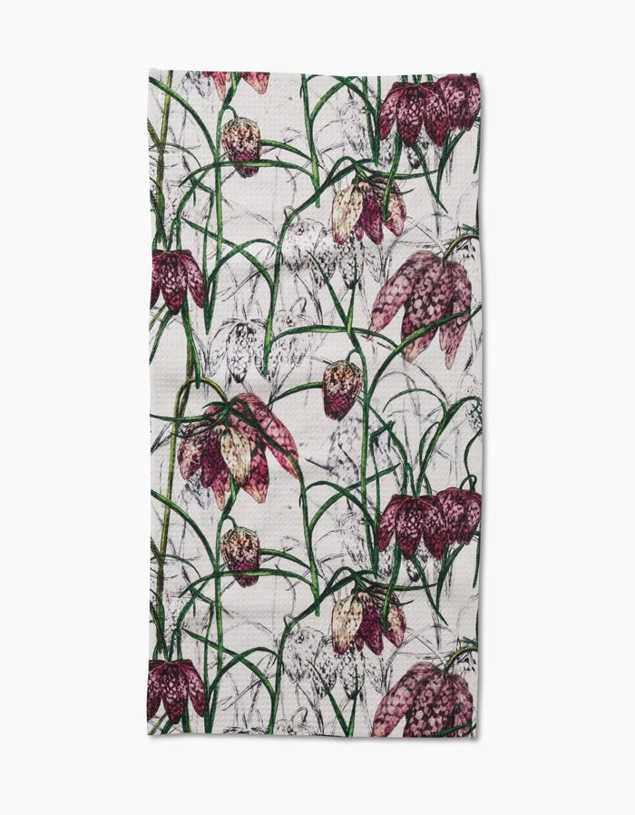 The Pascale Dilger Fritillaria tea towel features ultra-absorbent Geoweave fabric and a botanical print of purple and pink fritillaria flowers with green stems on a white background.