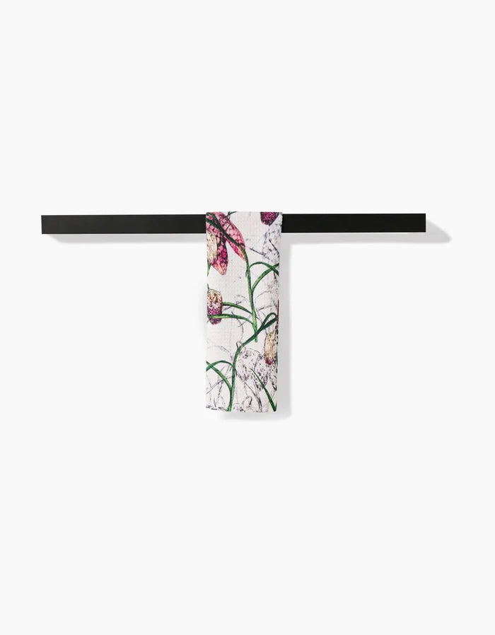 The Pascale Dilger Fritillaria set features a black horizontal towel bar and an ultra-absorbent Geoweave towel with green stems and pink flowers on white, shown against a plain background.