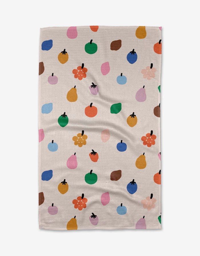 The Fruit Basket dish towel by Jennifer Bouron features a beige textured design with colorful, abstract fruit and flower shapes, adding playful charm to any space—perfect as a recycled kitchen towel or absorbent dish towel.