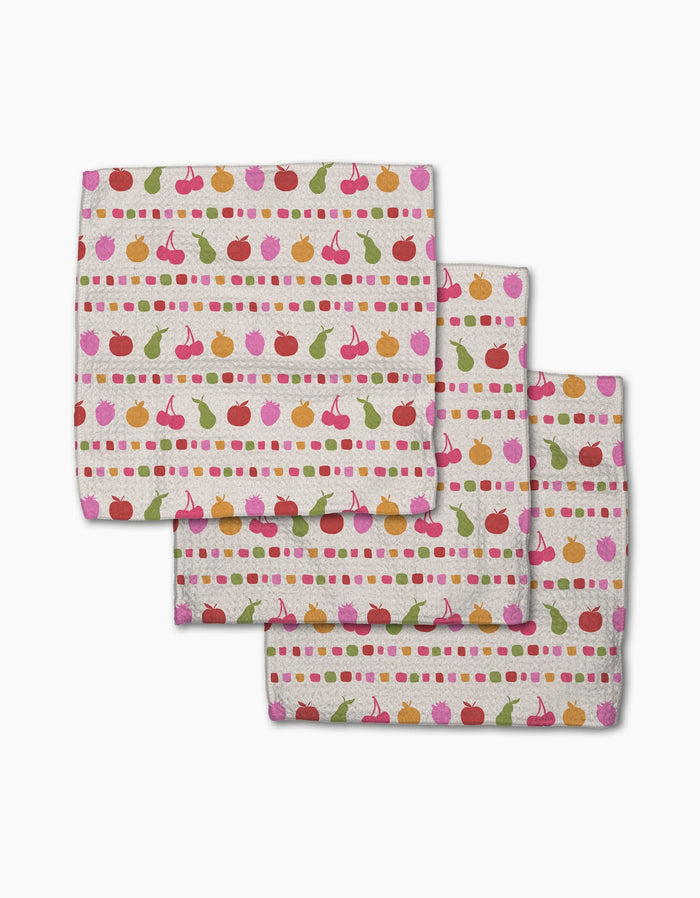 Geometry’s “Fruits At The Party” set includes three Geoweave napkins featuring cherries, apples, pears, and dots in colorful horizontal stripes on a light background.