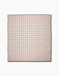 The Geometry Fruits Plaid is a square cloth beach blanket featuring a geometric pattern of small red squares and lines on a cream background with a thin black border. Its quick-drying design is evenly repeated across the entire surface.