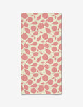 The Fruity Toss bar towel by Lizzie Clark is cream-colored and rectangular, with pink cherries and leaves in a diagonal pattern. Made from soft Geoweave fabric, it offers exceptional absorbency.