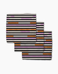 Three folded Geometry Funk On towels with horizontal stripes in black, white, light pink, purple, and orange—made from recycled materials—overlap each other on a plain white background.