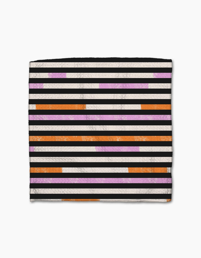 The Geometry Funk On square dishcloth, made from recycled materials, has horizontal black, white, orange, and purple stripes on white; the orange and purple stripes are short, broken segments.