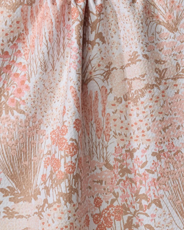 Close-up of the Garden Bloom kitchen tea towel by Hufton Studio, ultra-absorbent and made from recycled materials, with a soft pink, beige, and light brown floral pattern and gently gathered top for subtle texture.