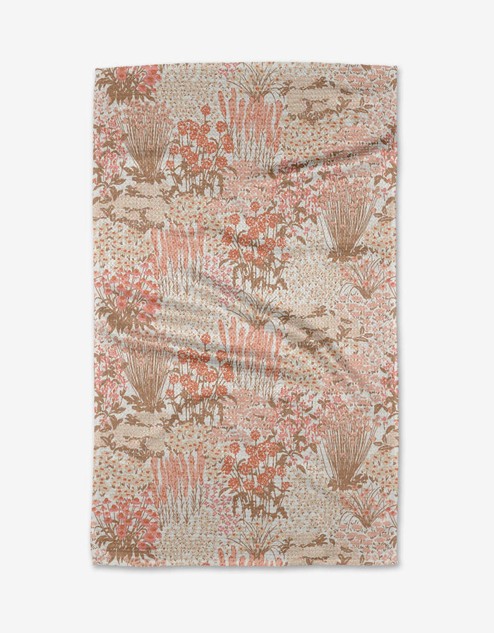The Hufton Studio Garden Bloom blanket features a soft beige base with pink, brown, and cream floral and foliage patterns, inspired by nature and crafted from recycled materials. Shown flat on a white background.