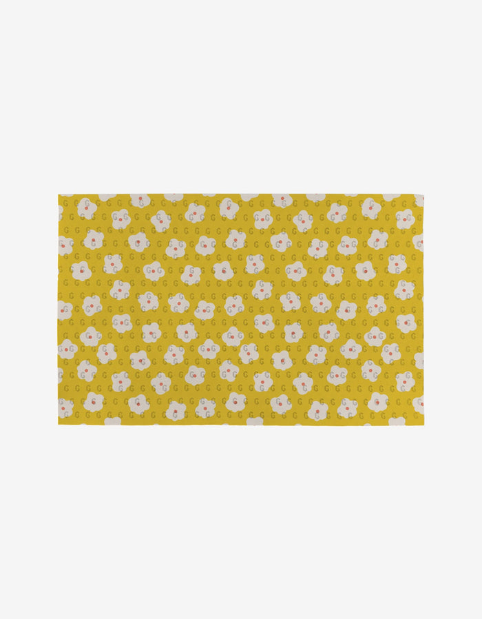 Garden Crush by Sara Mari is a rectangular yellow mat featuring evenly spaced white and light pink cartoon bear faces on a plain white background. Made from post-consumer recycled materials, its an eco-friendly choice for your home.