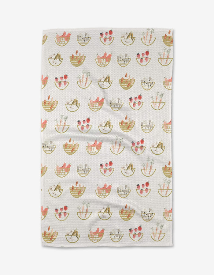 The Garden Fresh Tea Towel by Anee Shah features a charming pattern of baskets with cats and pink flowers in soft pink, tan, and green on a subtle grid. Made from Geoweave™ fabric for exceptional softness.