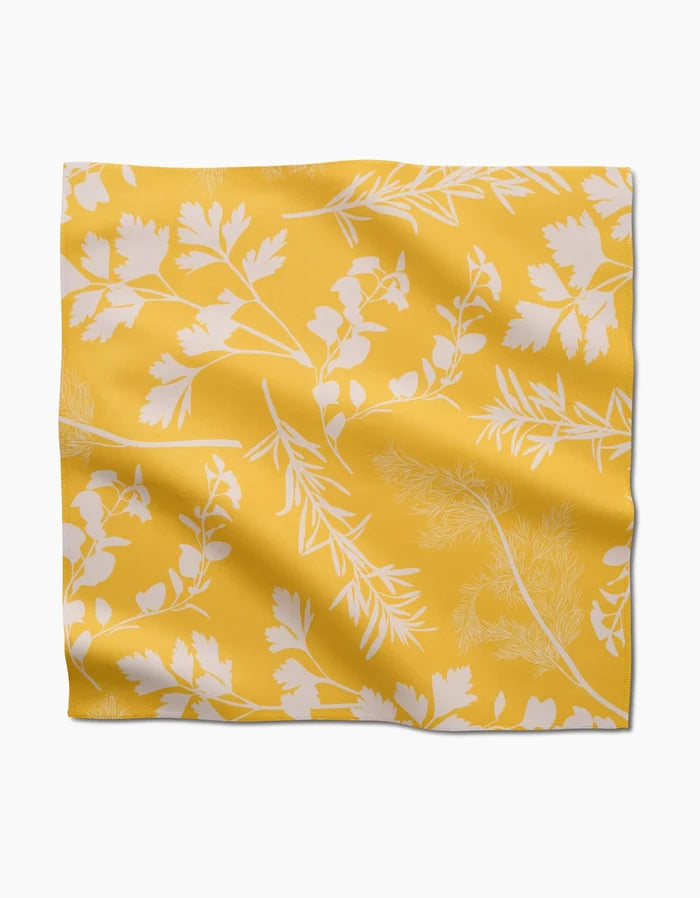 Garden of Gold by GEOMETRY: a yellow Geosuede™ dinner napkin with a white botanical pattern, made from recycled materials for eco-friendly elegance, shown flat with natural wrinkles.