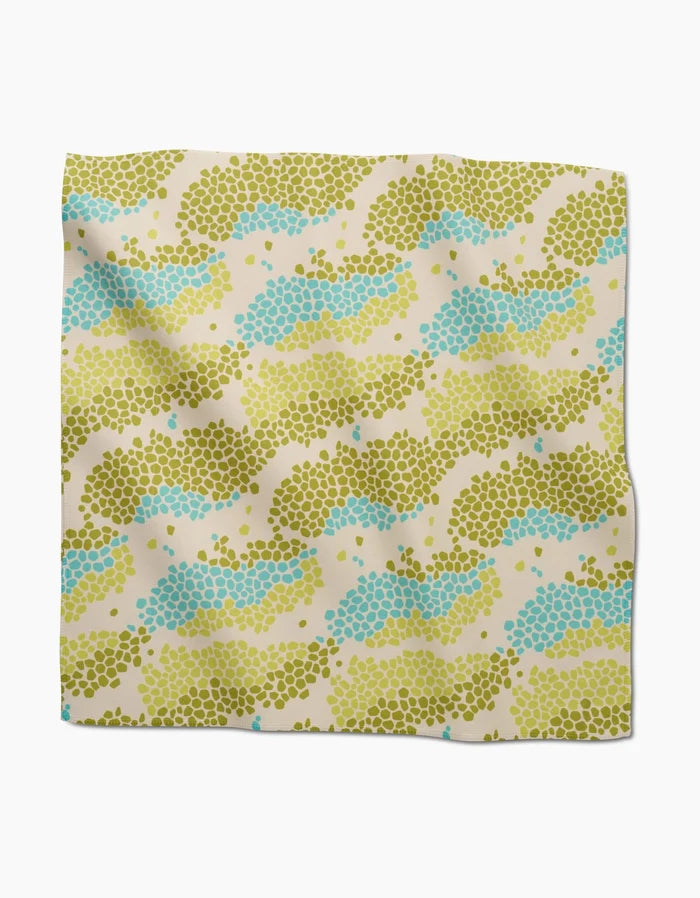 Geo Shell by GEOMETRY is a square, absorbent recycled dinner napkin with clustered olive green, light blue, and yellow dots in wavy stripes on beige—part of our eco-friendly collection.