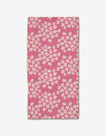 Lizzie Clark’s Geranium towel is a rectangular pink bar towel with scattered small white flowers, made from soft Geoweave fabric and shown flat on a white background.