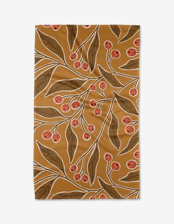 The Golden Berries napkin by Amy MacCready is a brown recycled-fabric napkin with dark green leafy branches, clusters of small red berries, and white outlines.