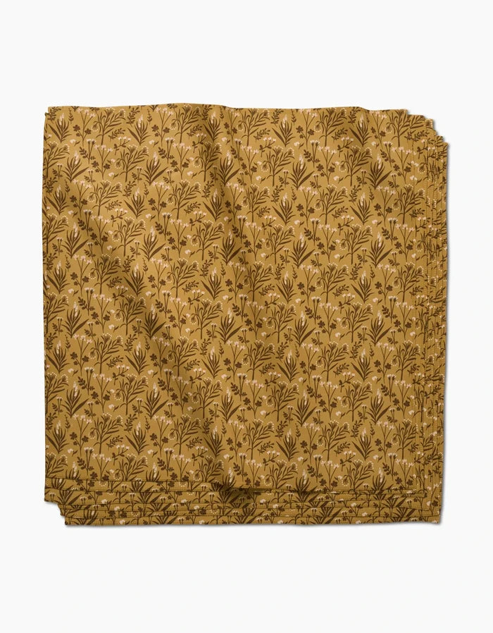 Golden Fall Flowers by Danelys Sidron features a mustard yellow fabric with a brown leafy print; this eco-friendly napkin adds charm to your table and comes as part of a recycled dinner napkin set.