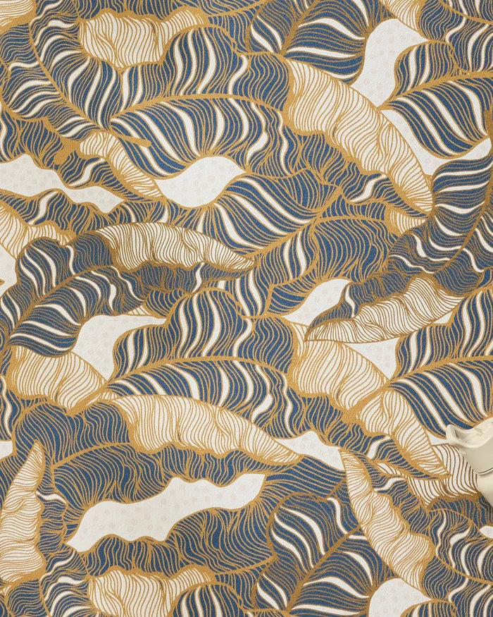 Golden Palms by Marina Solodka features abstract gold, navy, and white swirling patterns like leaves or waves, creating a calming vibe—perfect for a yoga towel—highlighted by a small white teapot in the lower right corner.