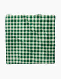 The Danelys Sidron Grass Plaid, a rectangular blanket with a green and white checkered pattern made from recycled materials, is displayed flat against a white background.