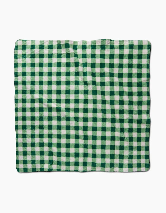 The Danelys Sidron Grass Plaid, a rectangular blanket with a green and white checkered pattern made from recycled materials, is displayed flat against a white background.