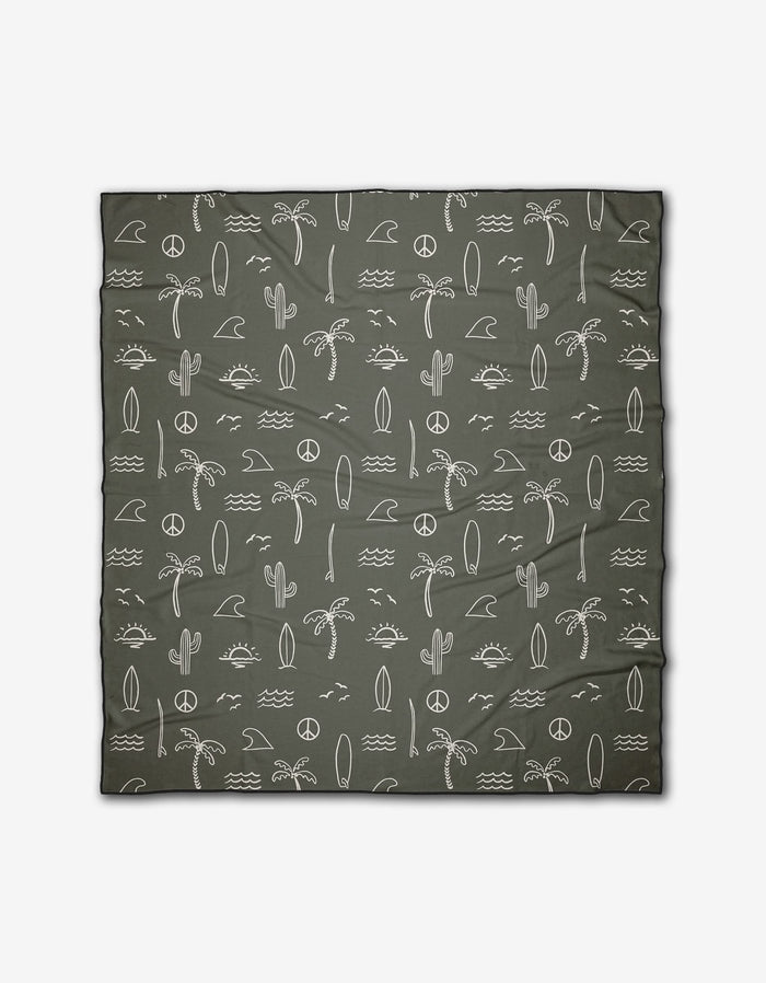 The Hufton Studio Green Summer Vibes beach blanket features white minimalist palm trees, cacti, waves, surfboards, suns, moons, and peace signs on recycled material. Quick-drying and ideal for any adventure.