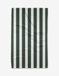 The Greens Tea Towel by BetterDays features vertical dark green and white stripes, is laid flat to show its textured Geoweave fabric with gentle creases, highlighting its durable construction.