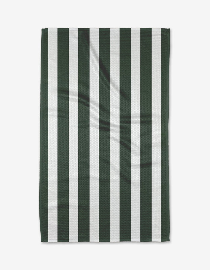 The Greens Tea Towel by BetterDays features vertical dark green and white stripes, is laid flat to show its textured Geoweave fabric with gentle creases, highlighting its durable construction.