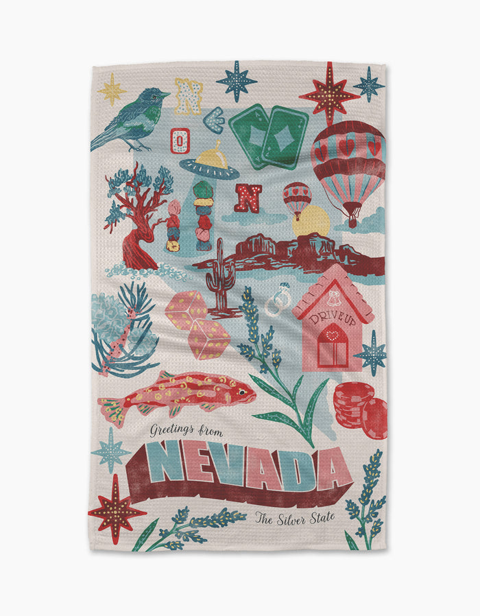 Geometry's "Greetings From Nevada" tea towel features vibrant Nevada icons—bird, dice, hot air balloon, cactus, slot machine—on ultra-absorbent recycled fabric, with “Greetings from Nevada, The Silver State” displayed.