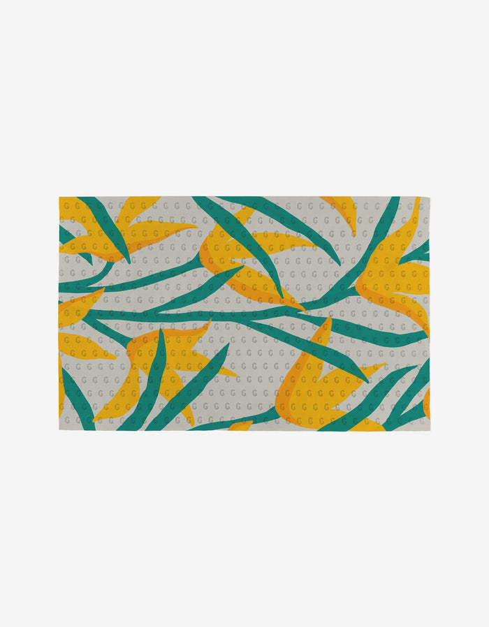 The GEOMETRY Growth mat features yellow and orange abstract flowers with green leaves on a light background with white circles, all crafted from eco-friendly materials.