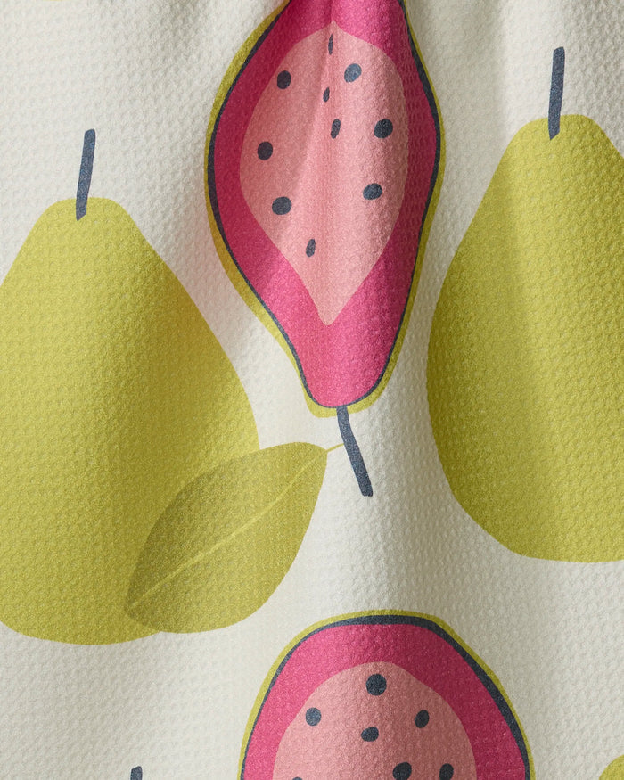 The Lizzie Clark "Guava Groove" recycled kitchen towel features abstract yellow pears and pink guavas with black seeds on a white textured background.